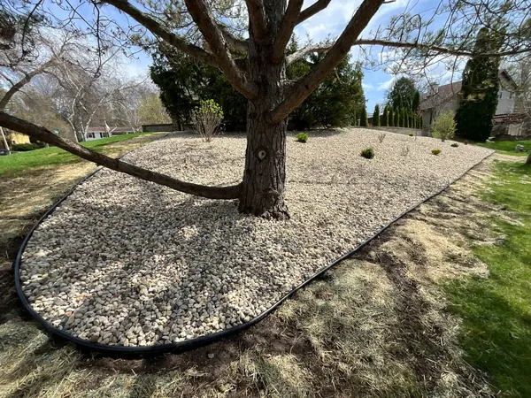 Completed decorative rock bed installation in Waukesha County