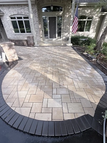 Finished paver front entry with a new gray block pattern and dark curved border