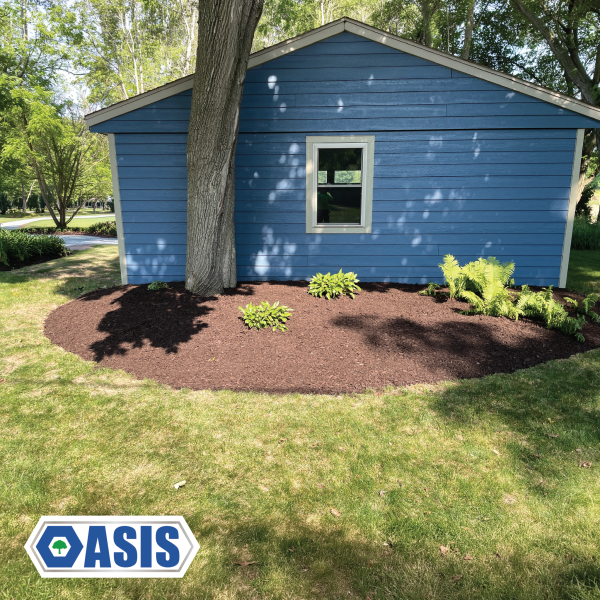 Brown mulch installation around residential landscape beds